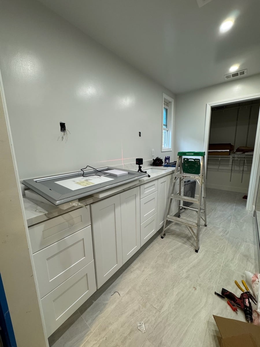 Before lighting installation - bathroom and under cabinet areas without proper lighting